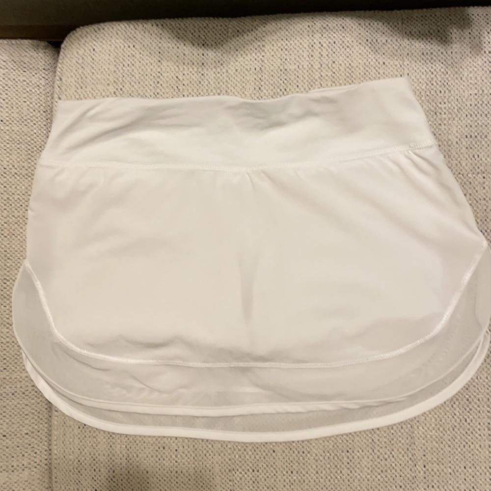 Lululemon size 4 white tennis skirt with mesh trim.